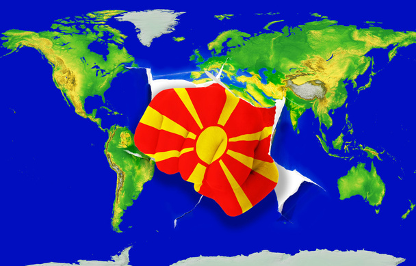 Fist in color national flag of macedonia punching world map - Photo, Image