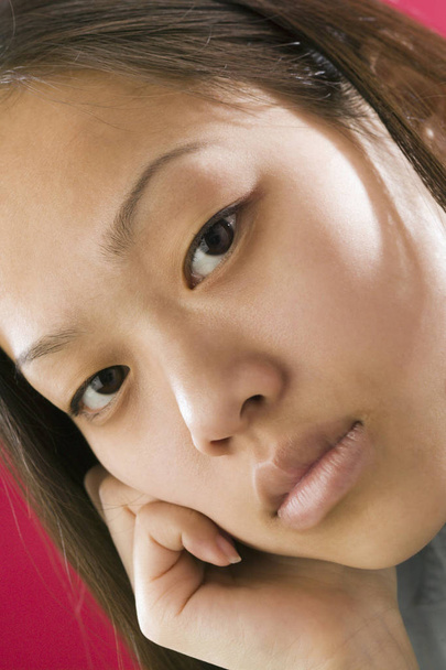 Close up view of a young Asian girl with an intense stare - Foto, Bild