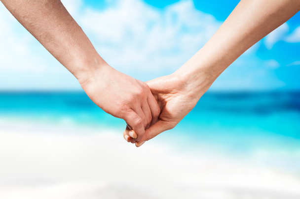 Держась за руки пара на пляже
 - Фото, изображение