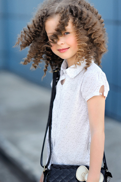 portrait of little girl outdoors iin the city - Fotó, kép
