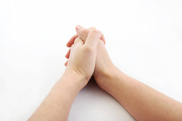 hands together resting on top of a  white plain background - Foto, imagen