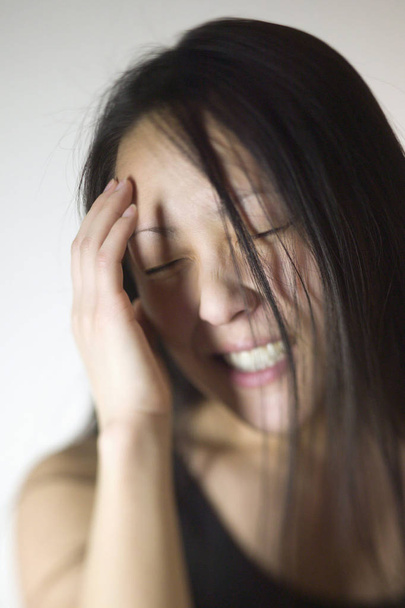 Young Asian woman with a headache - Zdjęcie, obraz