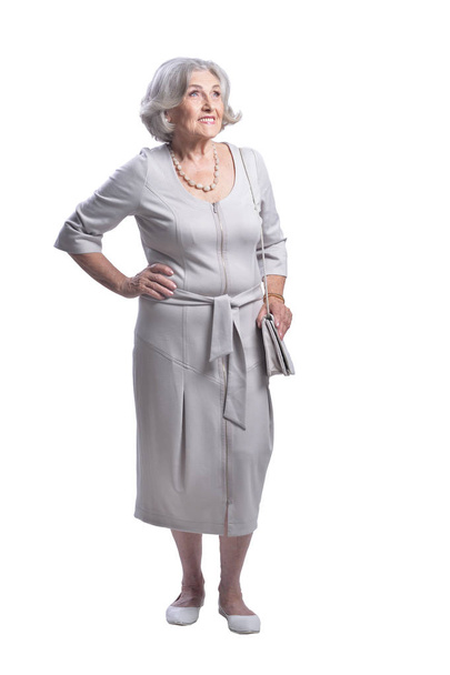 portrait of beautiful senior woman posing  against white background - 写真・画像