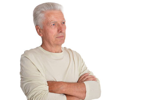 portrait of confident senior man with crossed arms posing isolated on white background  - Fotó, kép