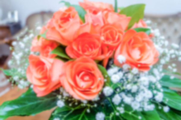 Defocused background with bouquet of roses. Intentionally blurred post production for bokeh effect - Foto, Imagen