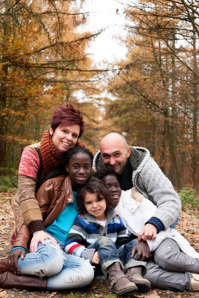 Happy family with foster children in the forest - Foto, Imagen