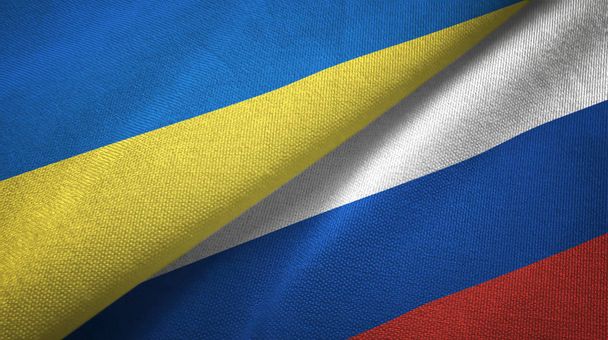 Ukraine and Russia two flags textile cloth, fabric texture - Photo, Image