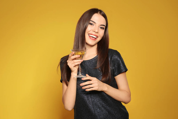 Beautiful young woman with glass of martini cocktail on color background - Foto, imagen