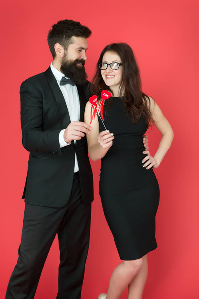business couple in love on meeting. valentines day heart. bearded businessman with lady on business meeting. formal couple. business meeting. love date. tuxedo man and elegant woman at formal party - Fotoğraf, Görsel