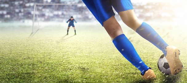 Football player man kicking the ball in the penalty box  - Foto, imagen
