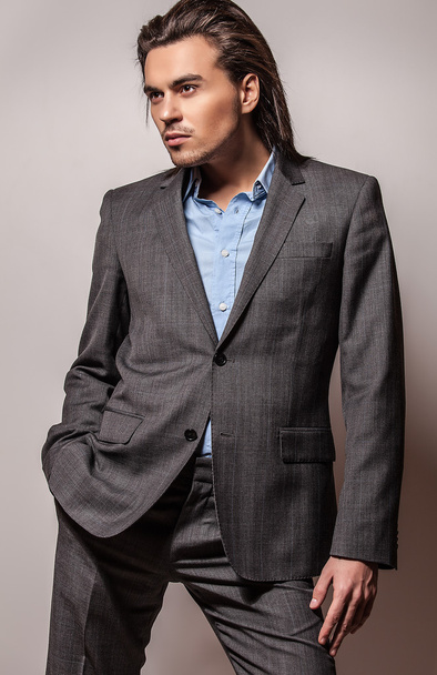 Elegant young handsome long-haired man in costume. Studio fashion portrait. - Fotoğraf, Görsel