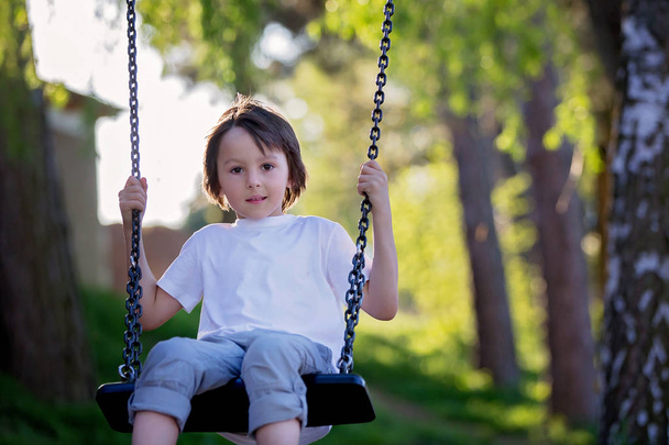 Child swinging on the playground  - Photo, Image