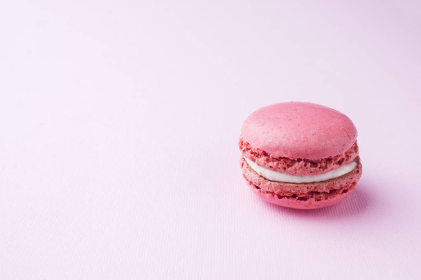 Pink dessert macaron or macaroons on pink background. Selective focus. Copy space - Фото, изображение