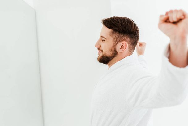 happy bearded man stretching after wake up in bathroom  - 写真・画像