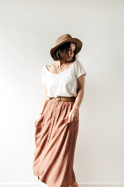 Young pretty woman in long skirt, hat, white blouse on white background. Fashion trendy stylish clothes look. - Foto, Imagem