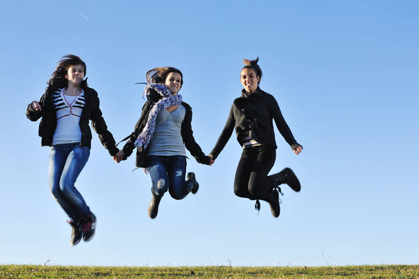 group of teen people woman  have fun outdoor with blue sky in background - Photo, Image