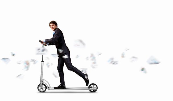 Businessman riding scooter - Фото, зображення