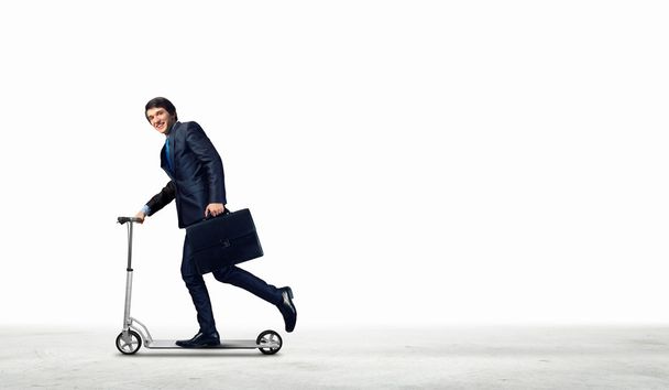 Businessman riding scooter - Photo, Image