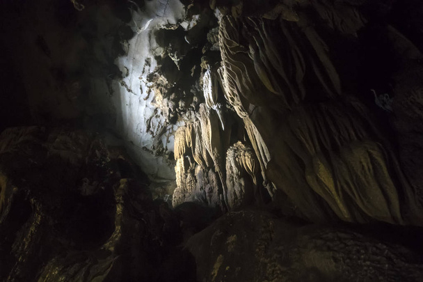 Limestone formations in karst cave at Cat Ba island, Vietnam, stalactites and stalagmites inside the cave - Photo, Image