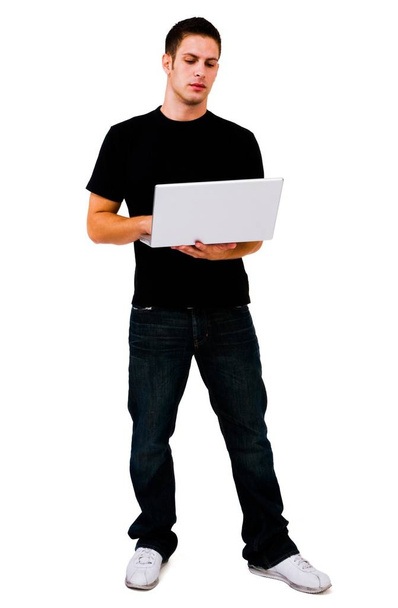 Man using a laptop and posing isolated over white - Foto, afbeelding
