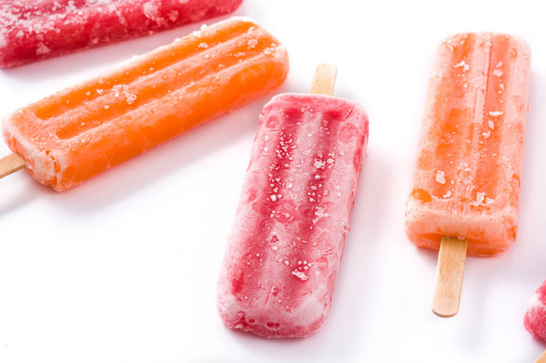Orange and strawberry popsicles isolated on white background. Close up - Φωτογραφία, εικόνα