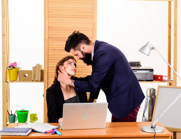 Couple who works together. Couple of lovers at workplace. Couple in love conducting affair at work. Romantic couple of handsome man and sensual woman in office - Fotoğraf, Görsel