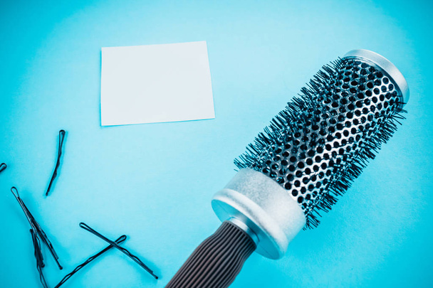 comb and hairpins on a blue background - Photo, Image