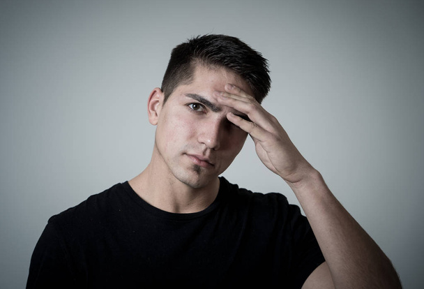 Close up portrait of handsome young mixed race man with headache suffering from migraines, hands on temples eyes closed showing strong pain. Facial expressions, people and Health care concept. - Photo, image