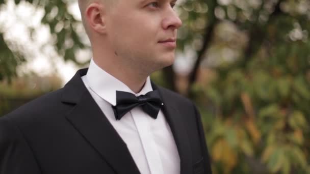 Close up of groom in black suit outside - Footage, Video