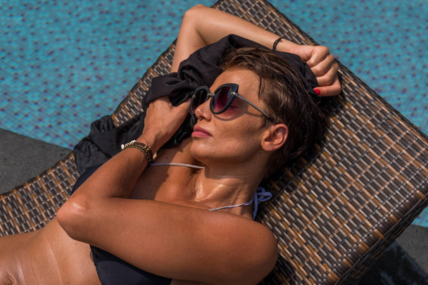 woman in luxury spa resort near the swimming pool.  - Фото, зображення