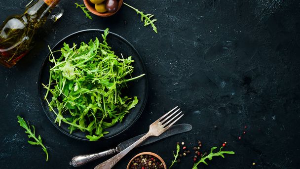 Arugula in a plate. Top view. Free space for your text. - Foto, Bild