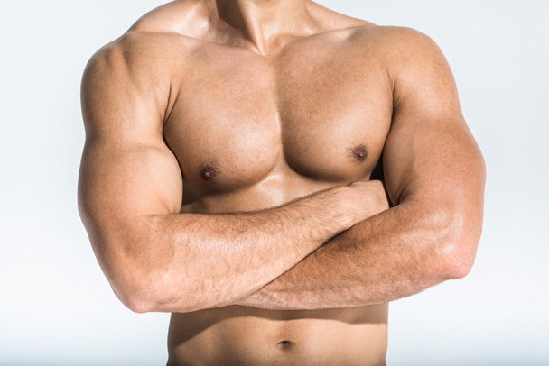 cropped view of athletic man with muscular torso posing on white - Foto, immagini