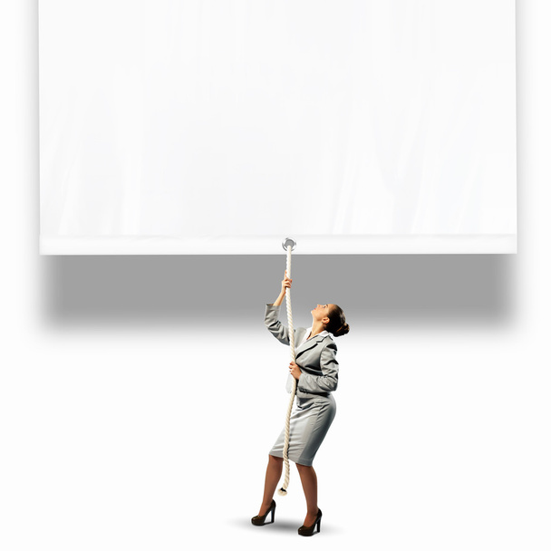 Businesswoman pulling banner - Valokuva, kuva