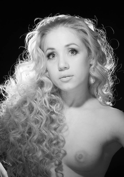 Portrait of a half-naked blonde on a black background. - Photo, image