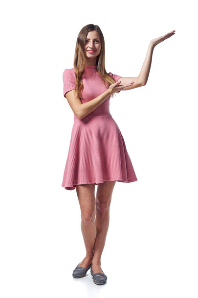 Woman in pink dress showing blank copy space - Фото, изображение