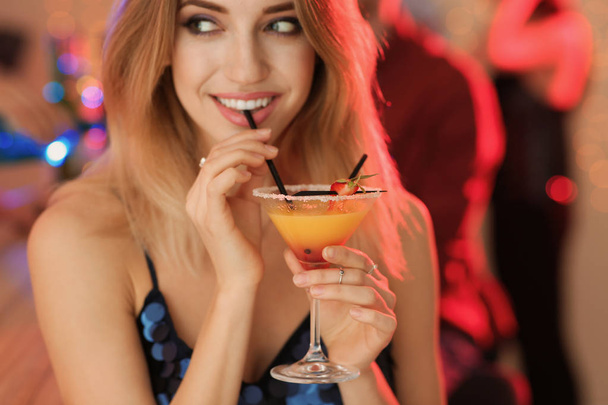 Beautiful young woman with glass of martini cocktail at party - Foto, afbeelding