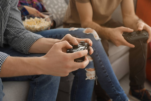 Group of friends playing video games at home, closeup - Foto, Imagen