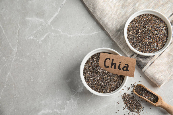 Flat lay composition with chia seeds on grey background. Space for text - Foto, Bild