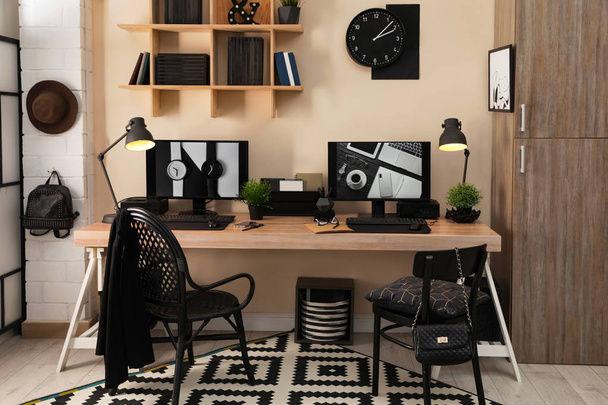 Stylish workplace interior with computers on table - Foto, imagen