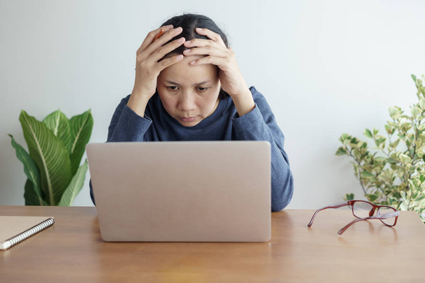 Asian women stressful working with a computer for a long time - 写真・画像