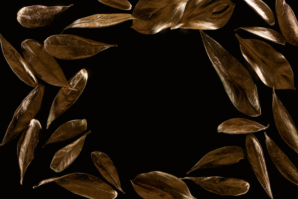 top view of frame made of golden metal leaves isolated on black with copy space - Photo, Image