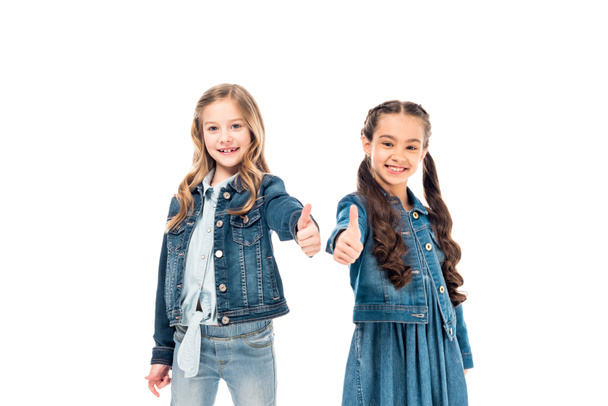 two smiling kids in denim clothes showing thumbs up isolated on white - Foto, Bild