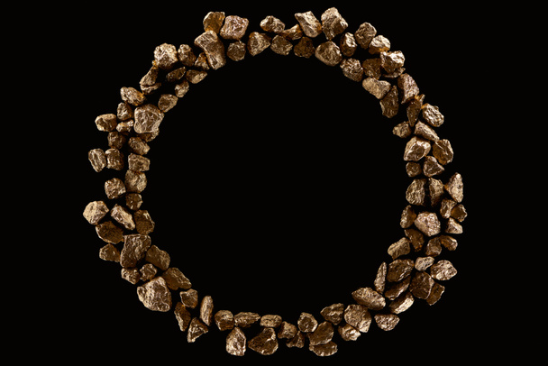 top view of round frame made of golden stones isolated on black with copy space - Photo, image