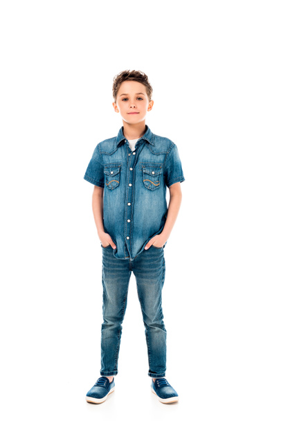 full length view of kid in denim clothes standing with hands in pockets isolated on white - Foto, Imagen