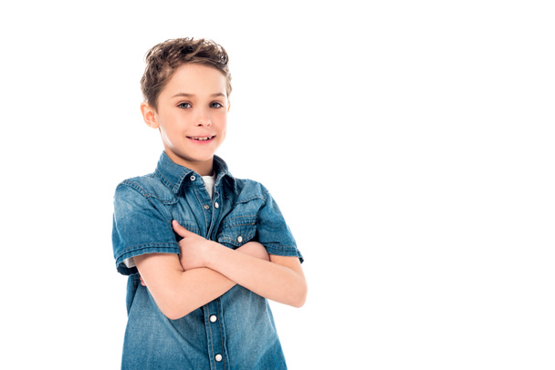 smiling kid in denim shirt posing with crossed arms isolated on white - Foto, Bild