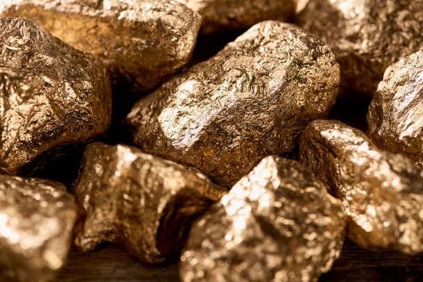 close up view of golden textured stones shining in sunlight - Fotografie, Obrázek
