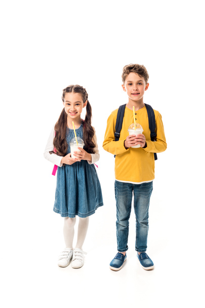 full length view of two kids holding milkshakes isolated on white - Photo, Image