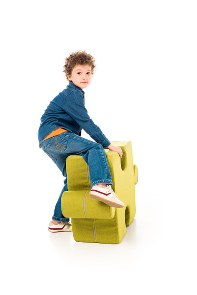 kid in denim clothes with big jigsaw puzzle on white - Foto, Imagem