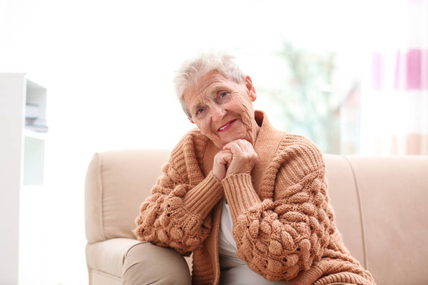 Portrait of beautiful grandmother in living room - Фото, зображення
