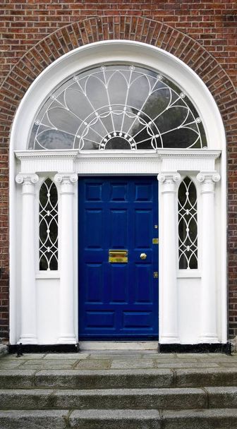 Georgian doorway in Dublin, Ireland, with cast iron fanlight and molded ionic columns - Photo, image